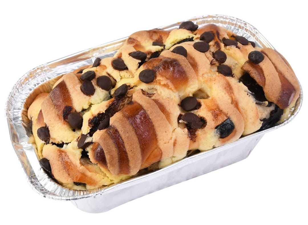 A delicious chocolate chip bread or cake in a foil baking pan.