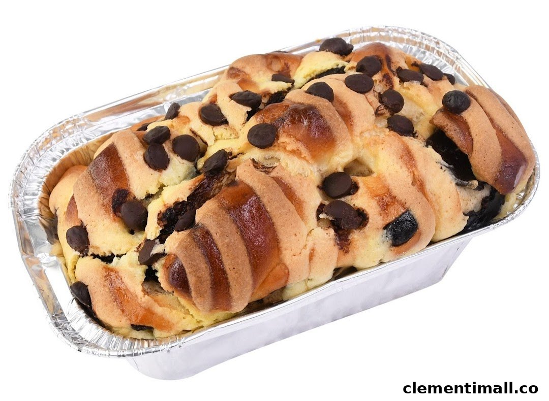 A delicious chocolate chip bread or cake in a foil baking pan.