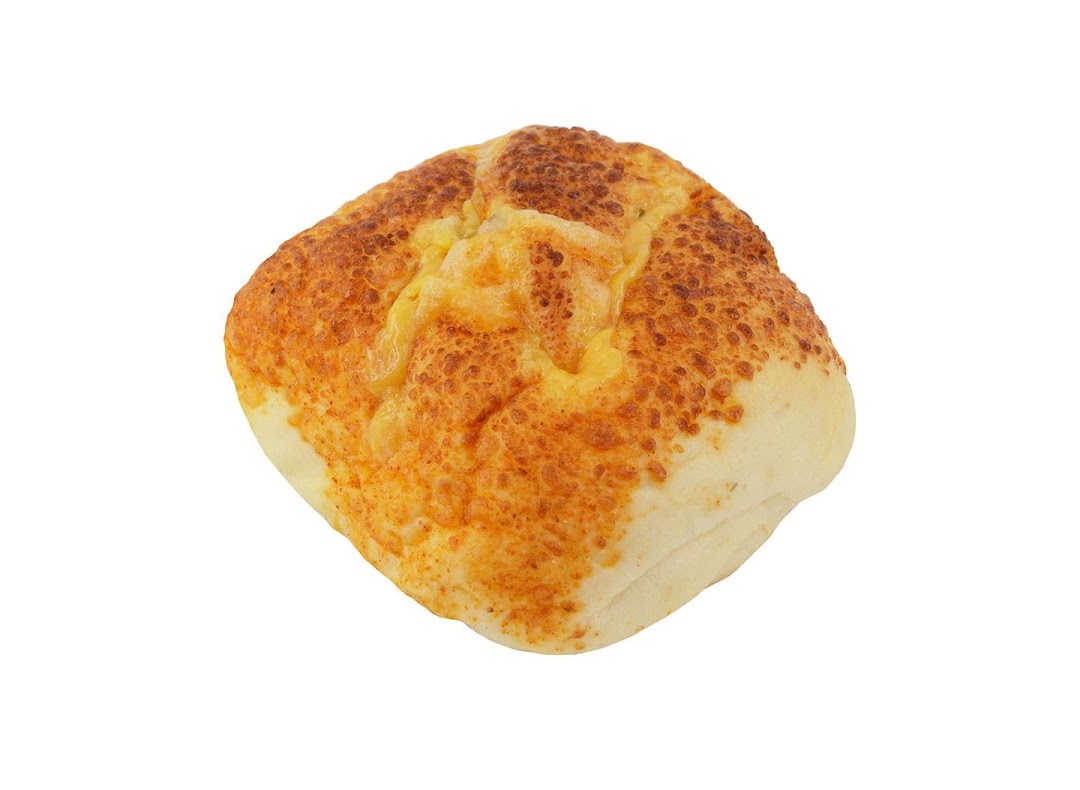 A golden-brown baked bun topped with melted cheese, isolated on a white background.