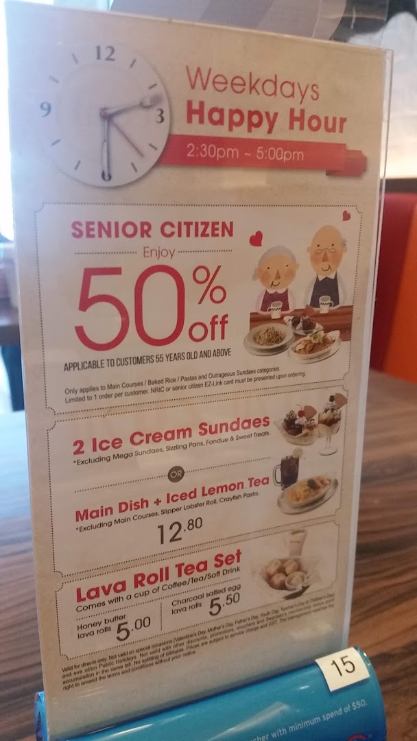A promotional stand displaying Swensen's happy hour, senior citizen discounts, and special set menus.