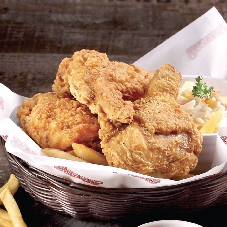 A basket of crispy golden fried chicken with fries and coleslaw from Swensen's.