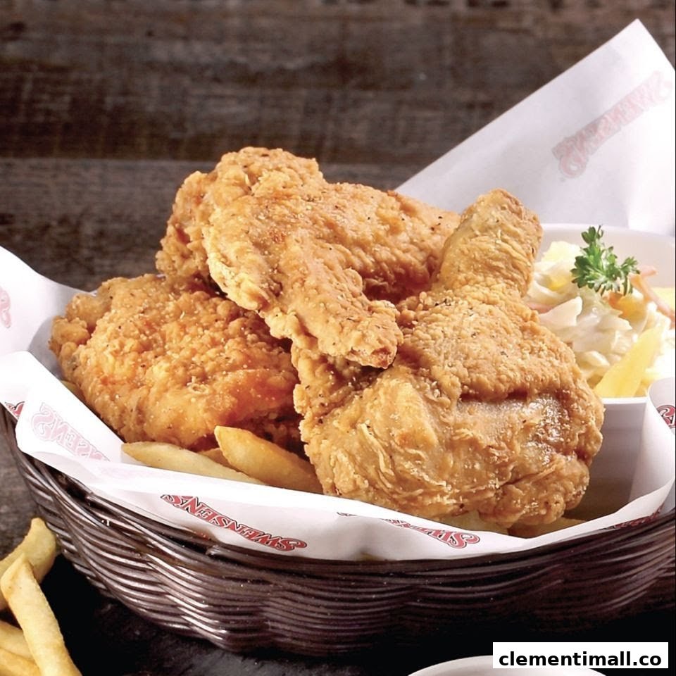 A basket of crispy golden fried chicken with fries and coleslaw from Swensen's.
