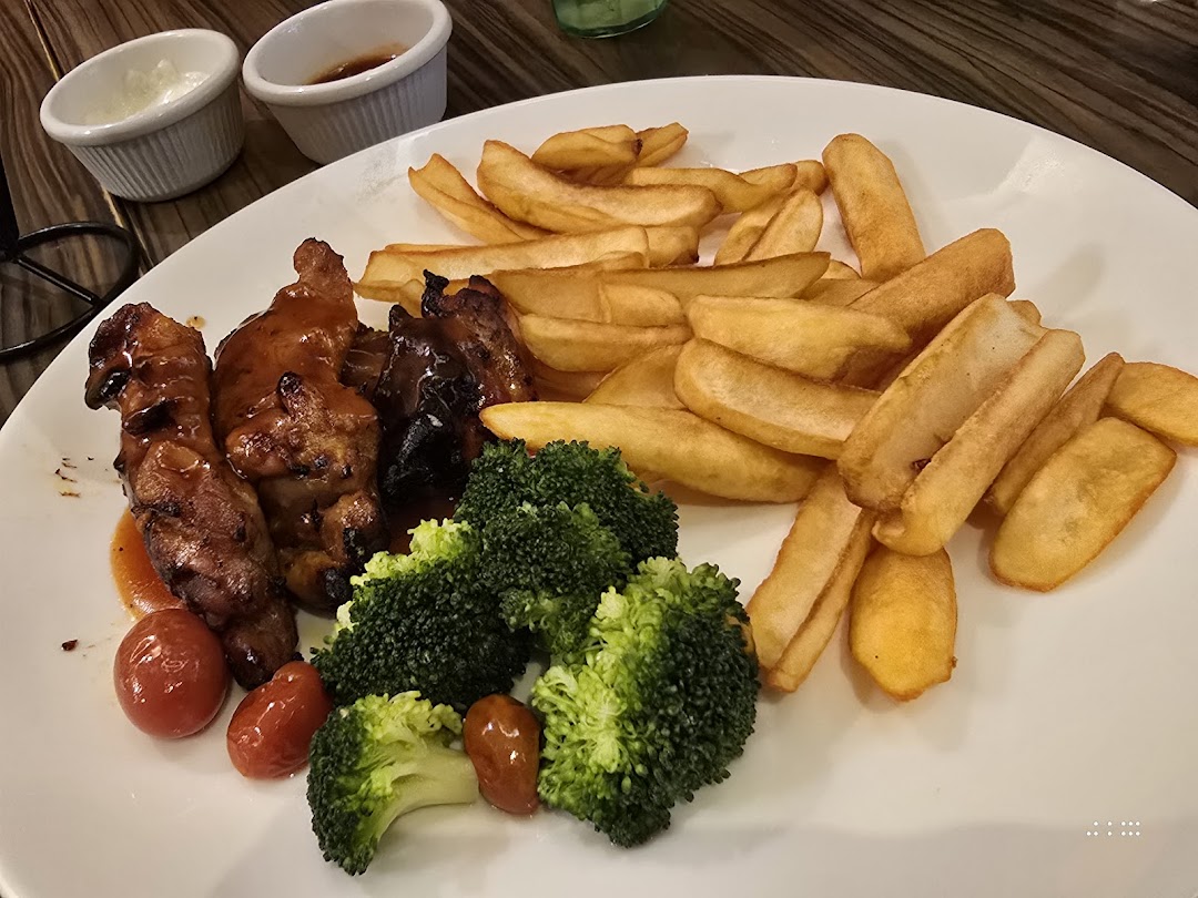 A delicious plate featuring grilled chicken, golden fries, fresh broccoli, and cherry tomatoes with dipping sauces.