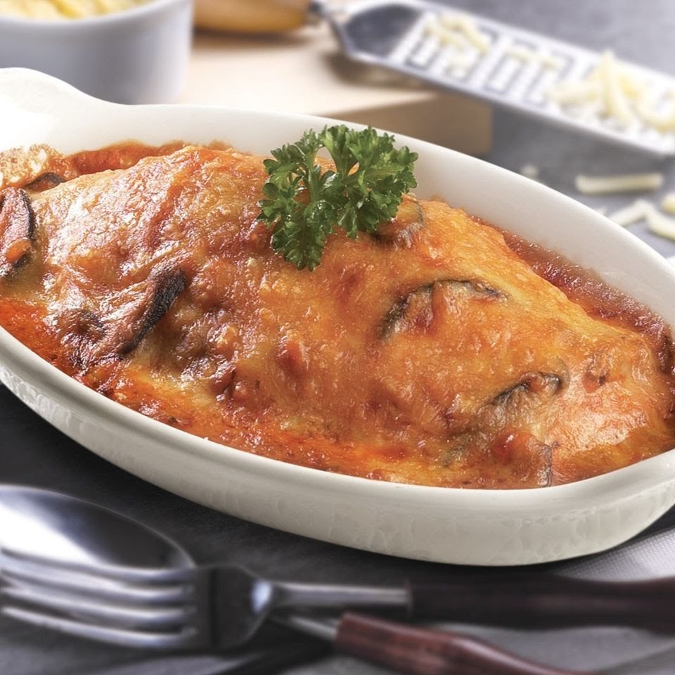 A close-up of a delicious baked pasta or casserole dish topped with melted cheese and parsley.