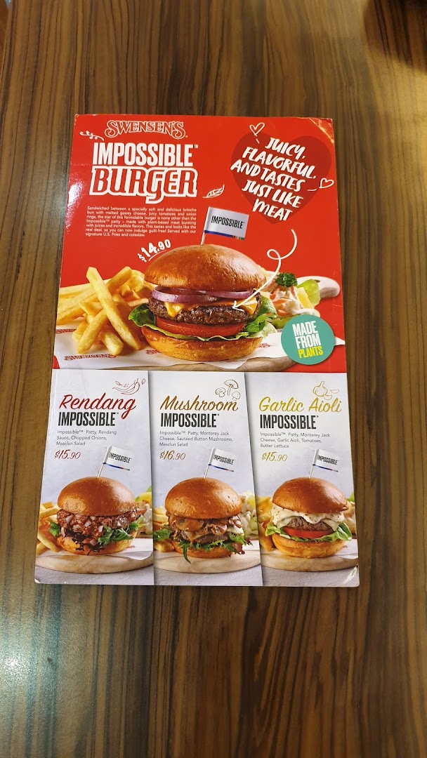 A Swensen's menu board showcasing their Impossible Burger range with various flavors.