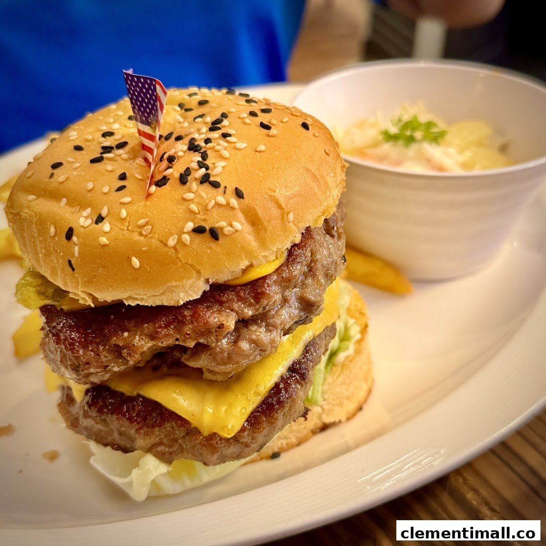 A delicious double-patty cheeseburger with fries and a side dish, served on a white plate.