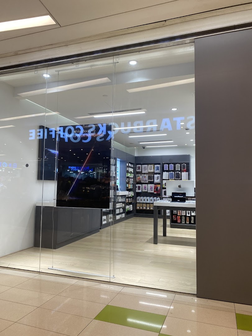 The glass entrance of Switch, an Apple Premium Reseller, showcasing Apple products and accessories.