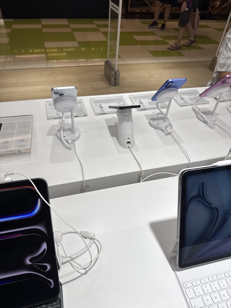 Close-up of a display table showcasing various Apple iPhones and iPads at Switch.