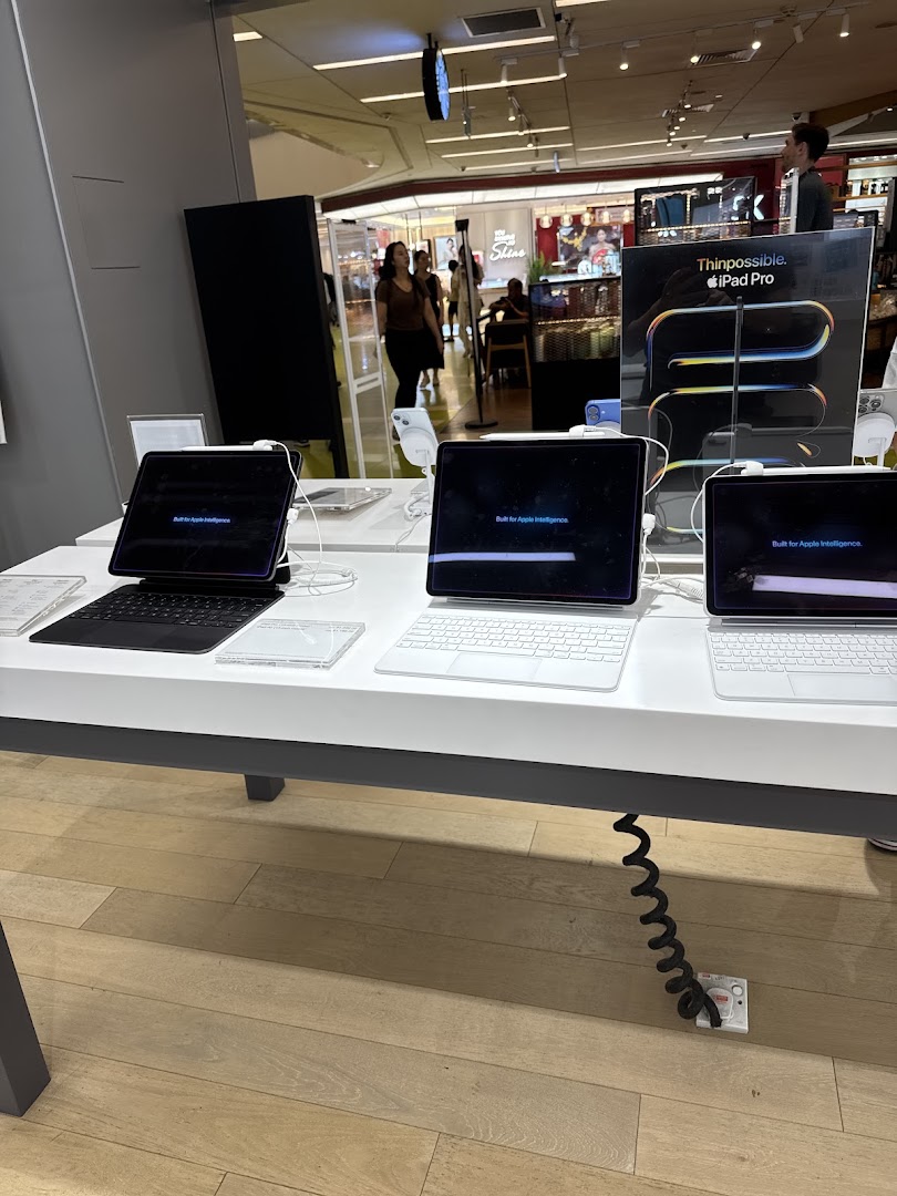 A display of Apple iPad Pro models with keyboards in a tech store.