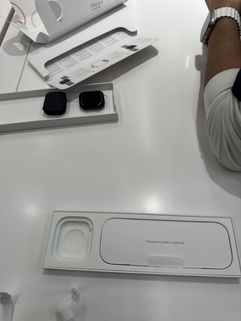 Close-up of Apple Watch products and packaging on a display table at Switch.