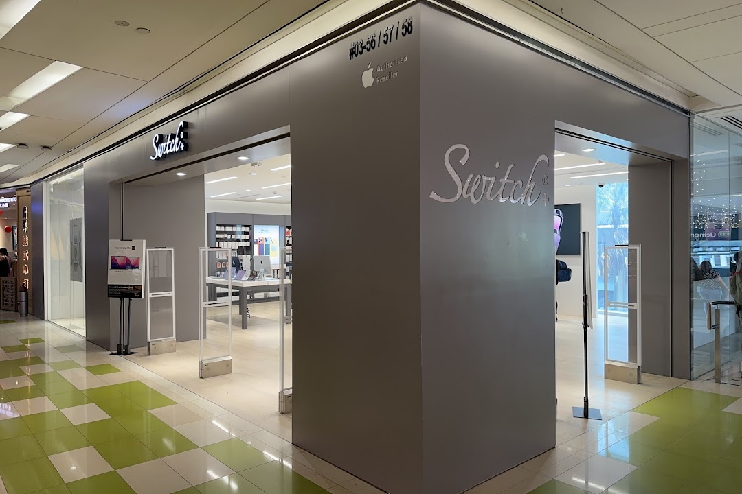 The storefront of Switch+, an Apple Authorized Reseller, showcasing its modern entrance and interior product displays.