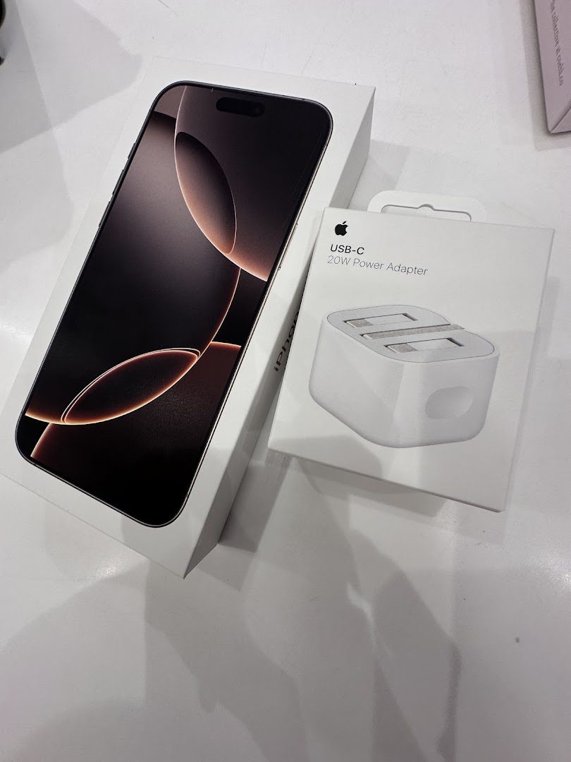 A new iPhone box and an Apple USB-C 20W Power Adapter box displayed on a white surface.
