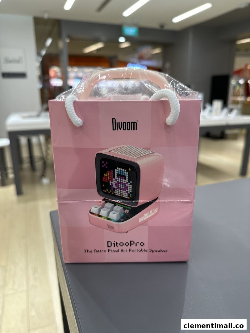 A pink Divoom DitooPro retro pixel art portable speaker in a shopping bag, displayed inside the Switch store.