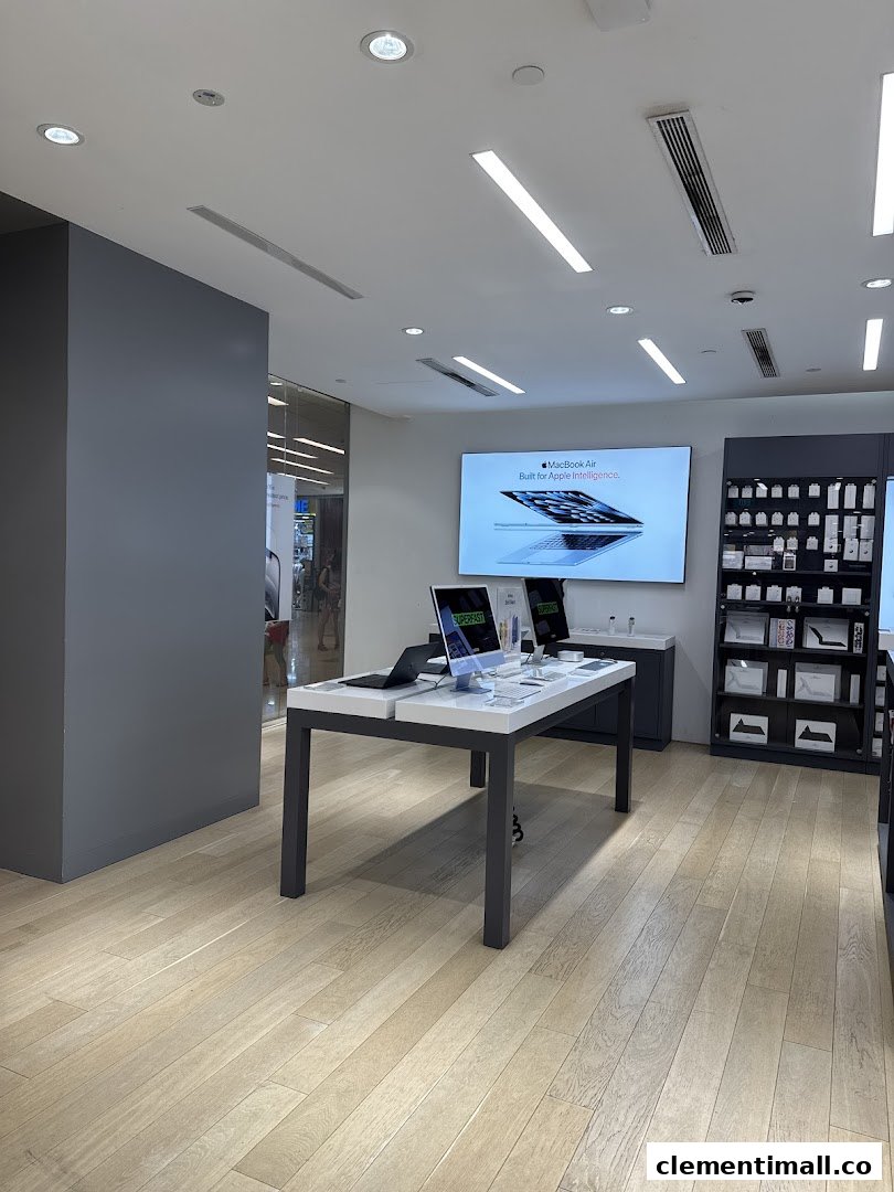 Interior view of Switch, an electronics store, showcasing Apple products on display tables and a large screen.