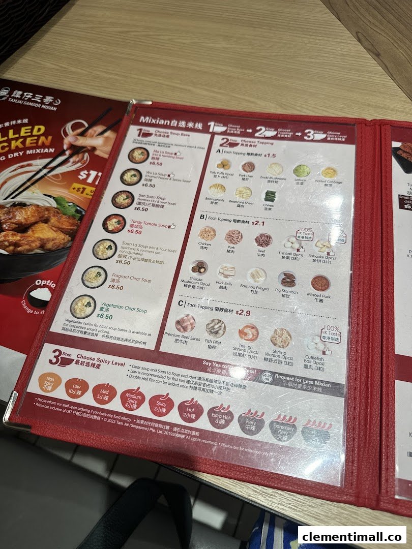 A detailed menu from TamJai SamGor Mixian, showcasing soup bases, toppings, and spice levels.