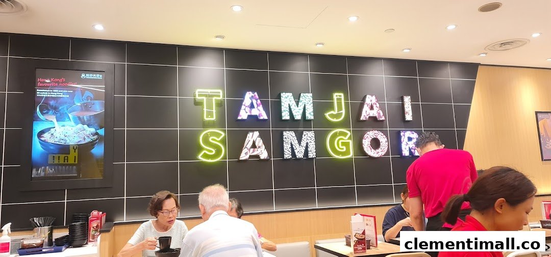 Customers dine inside TamJai SamGor Mixian, featuring the vibrant brand name on the wall.