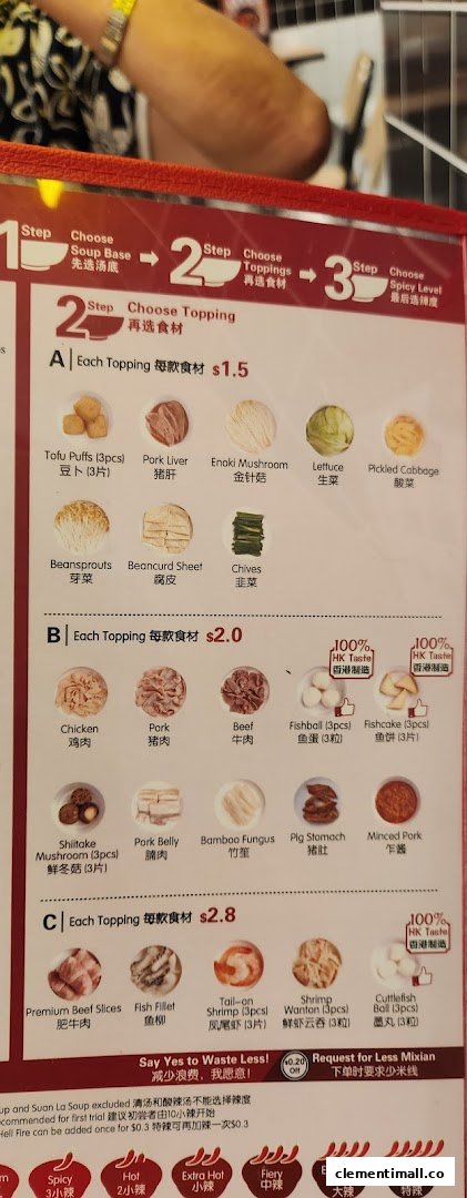 A detailed menu board displaying topping options and pricing for TamJai SamGor Mixian.