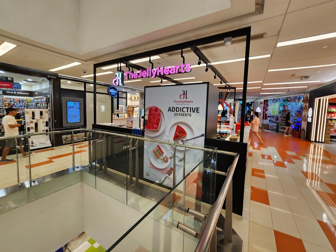 The JellyHearts dessert shop with 'Addictive Desserts' signage, located in a bustling mall corridor.