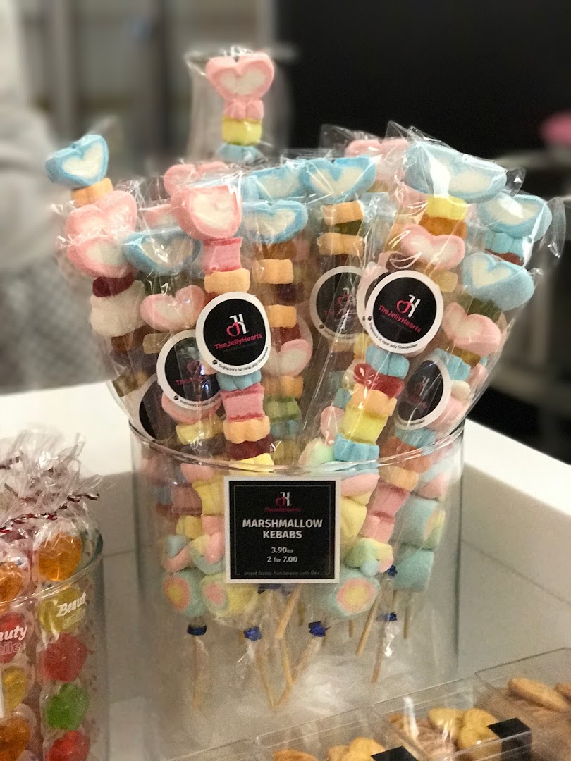 A vibrant display of colorful marshmallow kebabs from The Jelly Hearts, individually packaged for sale.