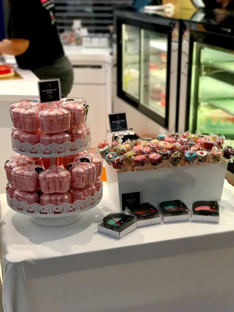 A vibrant display of marshmallow hearts, cake pops, and chocolate cookies at The JellyHearts.