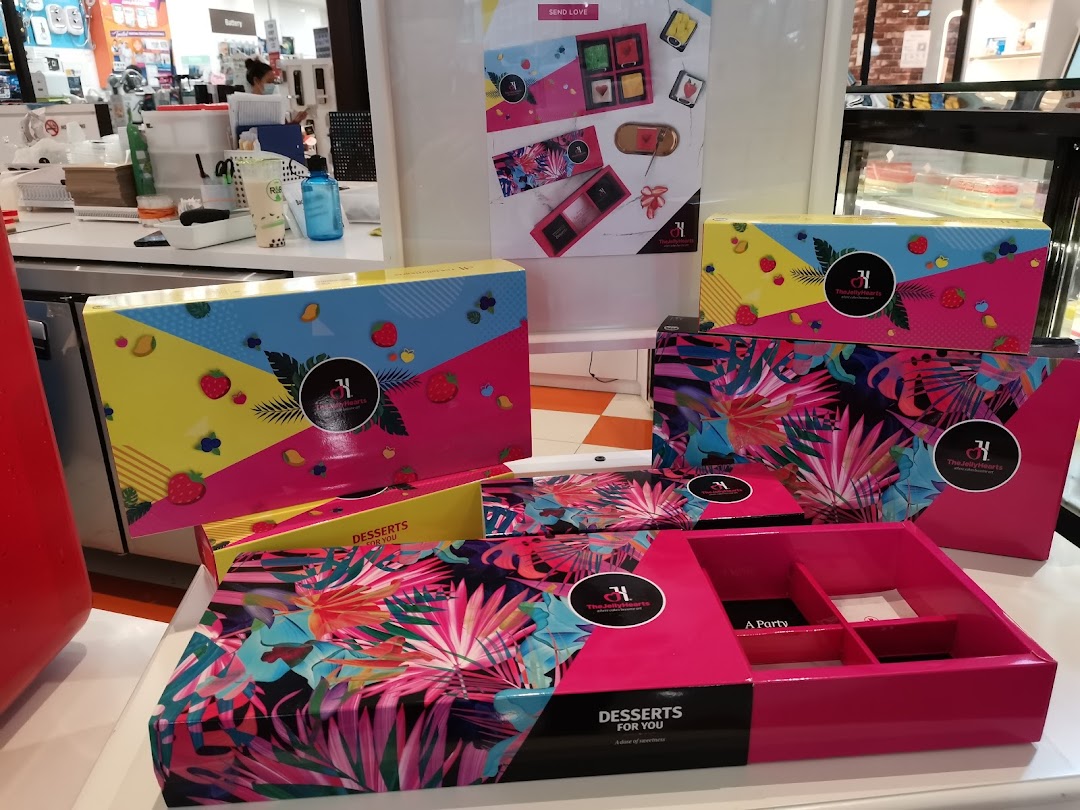 Vibrant, tropical-themed dessert gift boxes from The JellyHearts are displayed, perfect for special occasions.