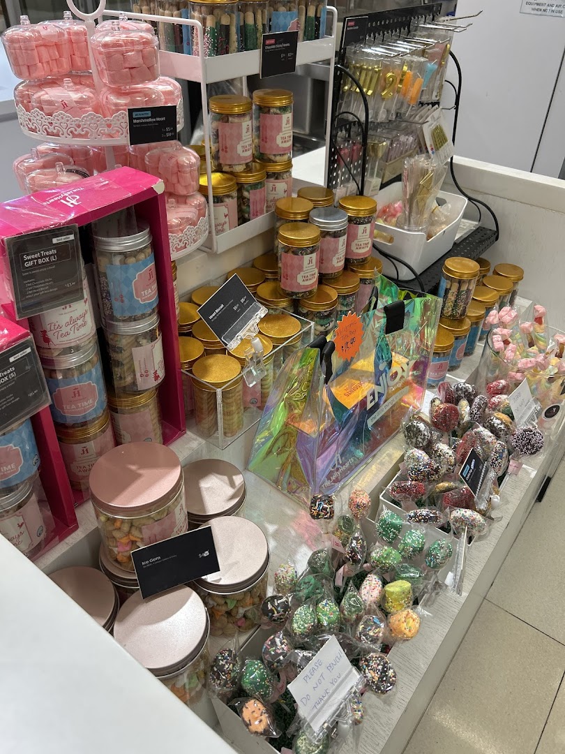 A vibrant display of various sweet treats, cookies, and gift items inside a confectionery shop.