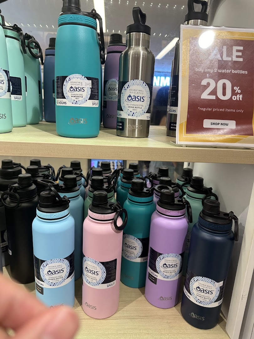 Colorful Oasis brand insulated water bottles are displayed on shelves with a 20% off sale sign.