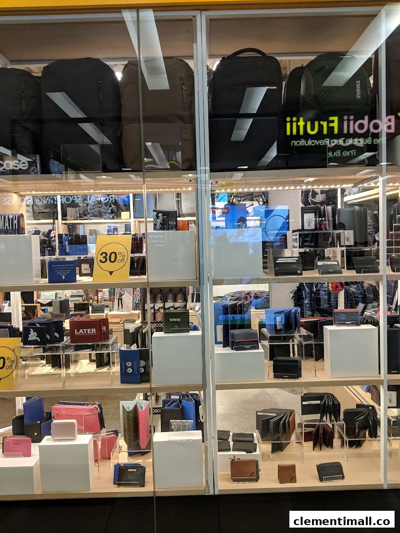 The Wallet Shop's storefront displays a wide array of wallets, bags, and accessories, including backpacks and small leather goods.