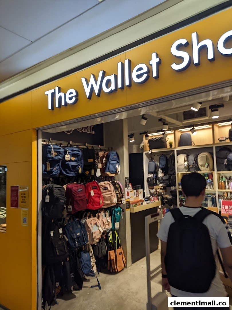 The storefront of The Wallet Shop, showcasing a wide array of bags and wallets, with a customer entering.