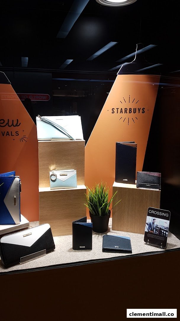 A well-lit display showcasing a variety of stylish wallets and small leather goods in a retail shop.