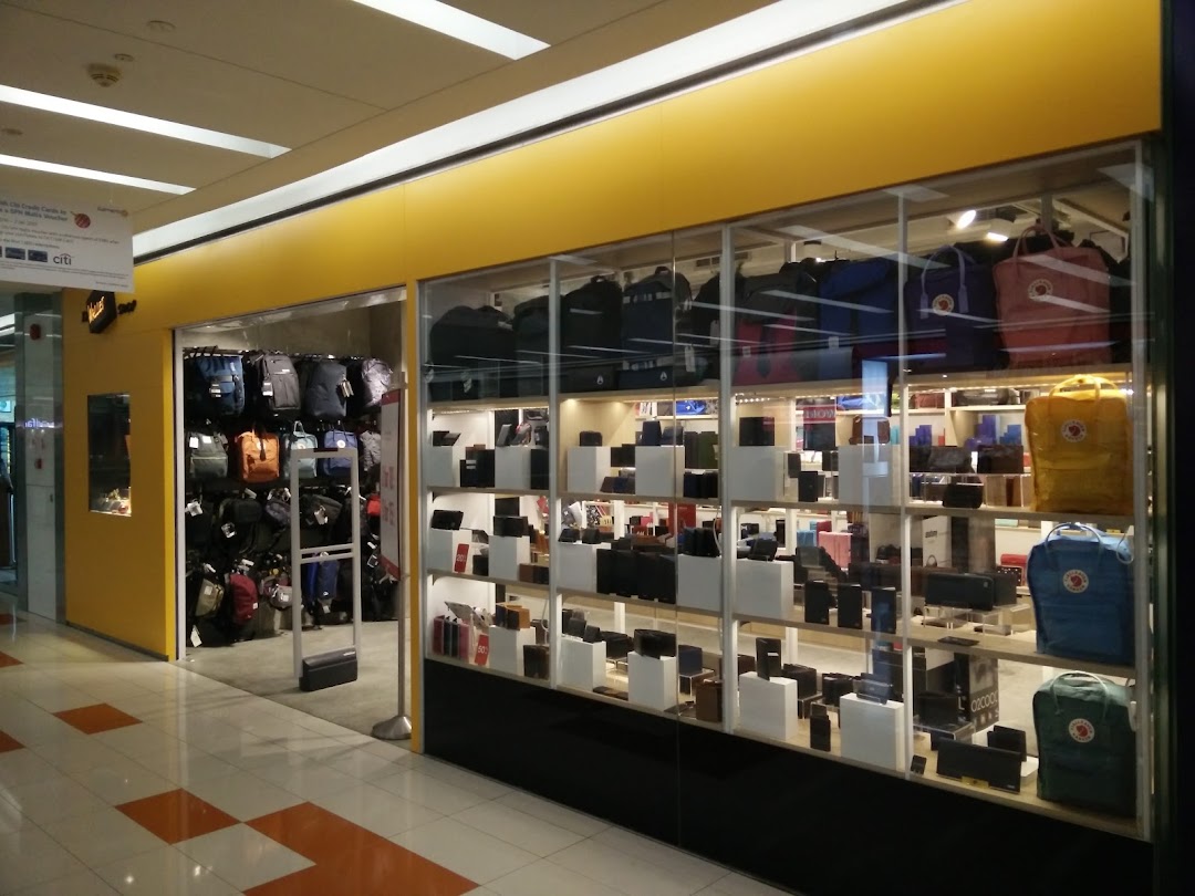 The storefront of The Wallet Shop, showcasing a wide array of wallets, bags, and accessories in its display windows.