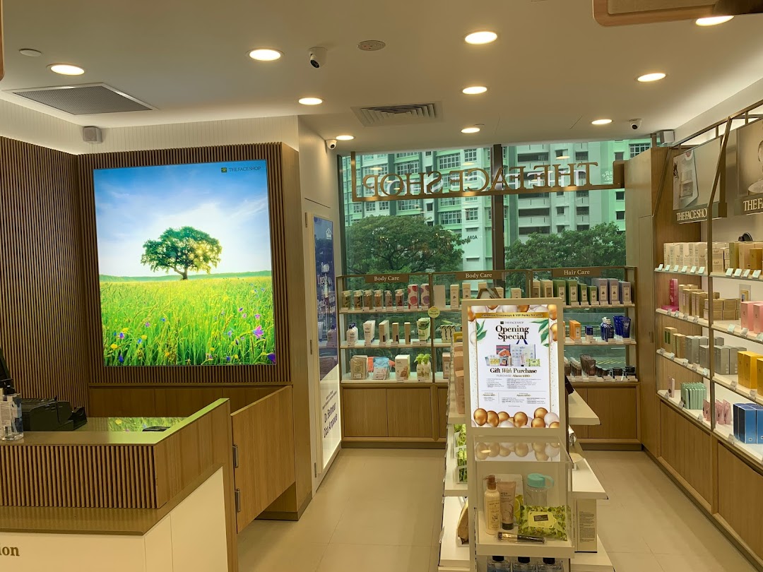 Interior view of THEFACESHOP, showcasing skincare and beauty products on display shelves and a bright nature-themed wall.