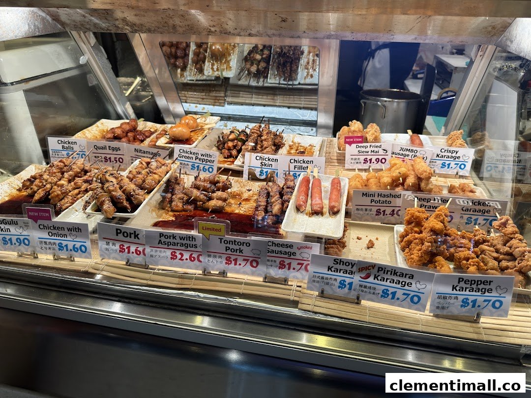 A vibrant display case showcasing a variety of Japanese skewers, fried items, and snacks with prices.