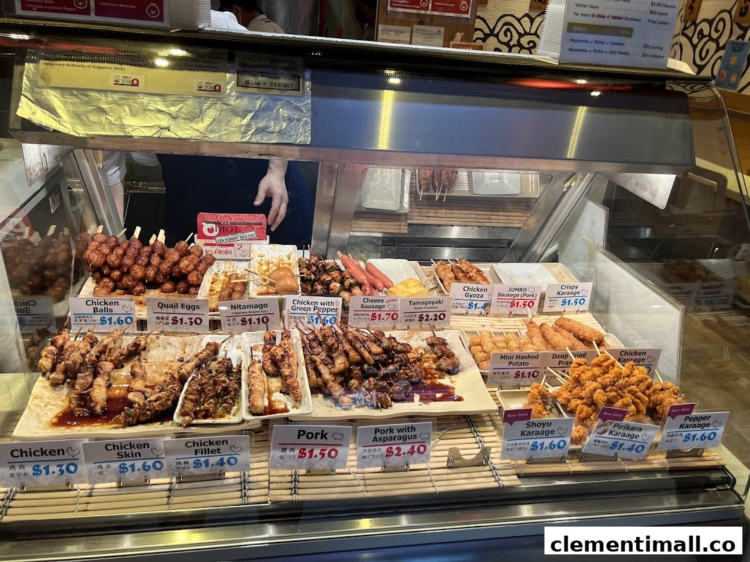 A vibrant display of Japanese skewers and fried items with prices at a food stall.