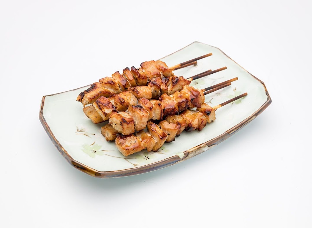 A plate of delicious grilled chicken skewers, perfectly cooked and glazed.