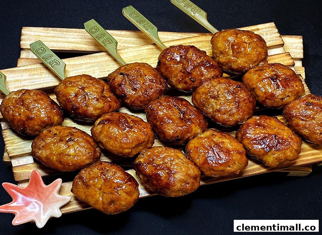 Delicious glazed meatballs on skewers arranged on a wooden tray, with a small star-shaped dish.