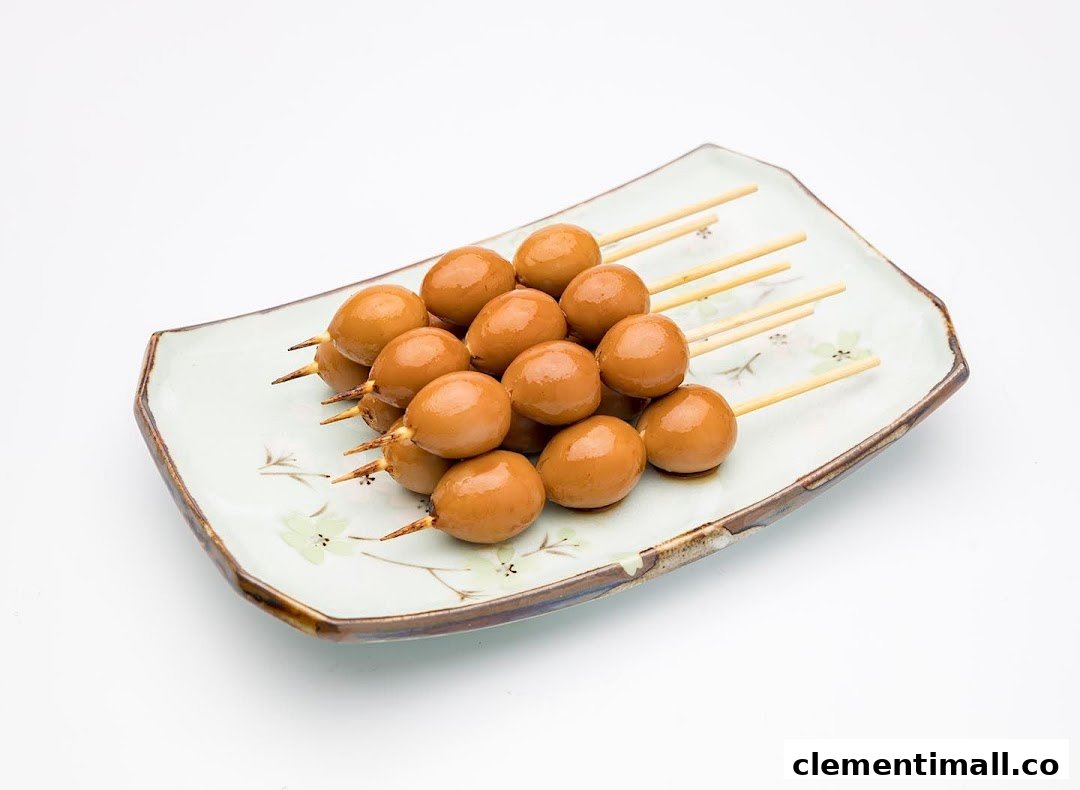 A plate of savory brown quail eggs on wooden skewers, ready to eat.
