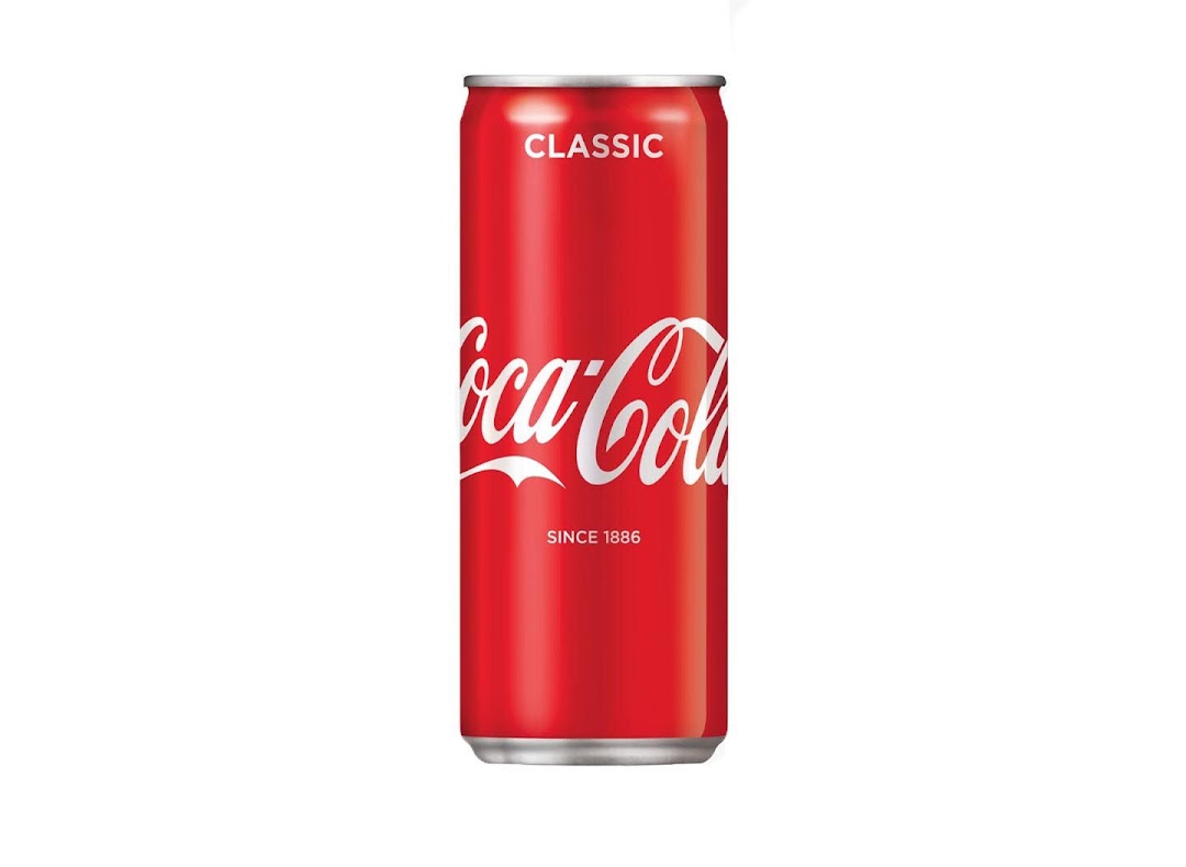 A red Coca-Cola Classic can with white logo on a plain white background.