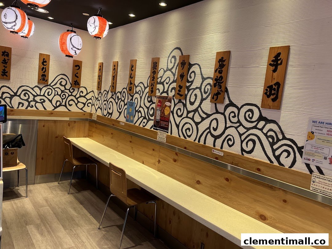 A cozy interior view of TORI-Q, featuring counter seating, Japanese lanterns, and traditional decor.