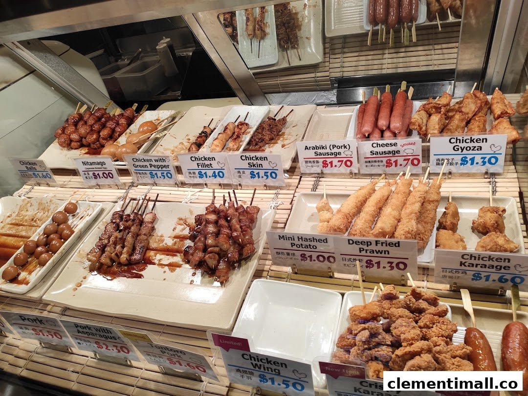 A vibrant display counter showcasing various Japanese skewers, fried items, and sausages with prices.