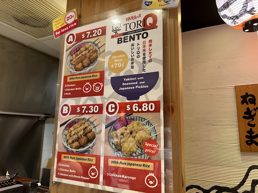 A menu board displaying various bento sets with yakitori and karaage options at TORI-Q.