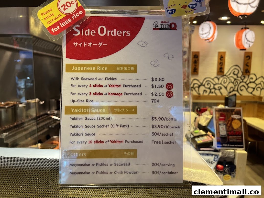 A detailed menu board displaying side orders, rice, and sauce options with prices at TORI-Q.