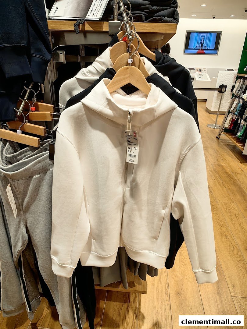 A rack of comfortable hoodies and sweatpants displayed inside a UNIQLO store.