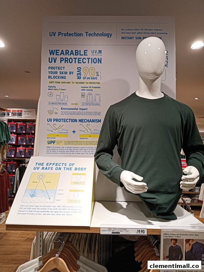 A mannequin displays UNIQLO's AIRism UV Protection long-sleeve shirt with informational signage.