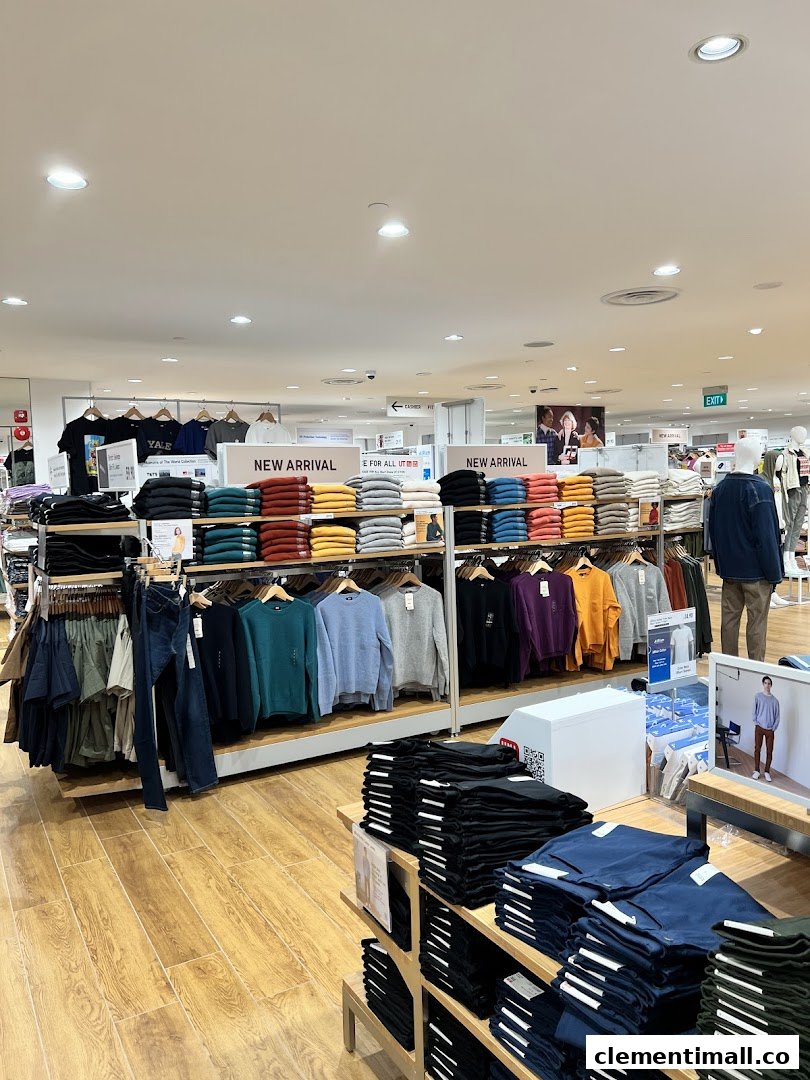An interior view of UNIQLO, showcasing neatly folded and hung apparel, including new arrivals.