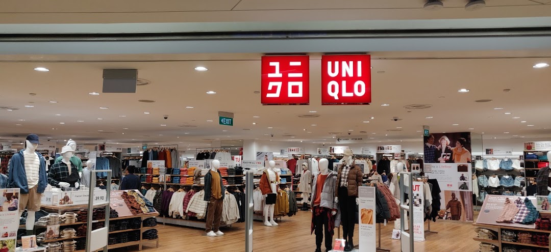 The bright and inviting entrance of UNIQLO at The Clementi Mall, showcasing diverse clothing displays.