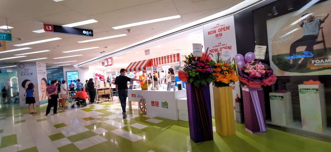 The UNIQLO shop front at The Clementi Mall, featuring promotional displays and shoppers.