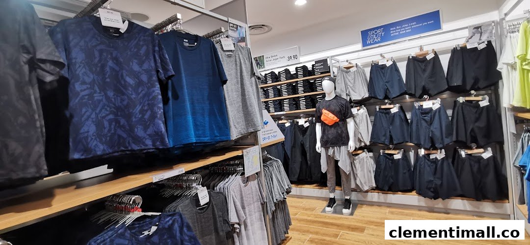 An interior view of UNIQLO showcasing a range of men's activewear and casual apparel on racks and a mannequin.