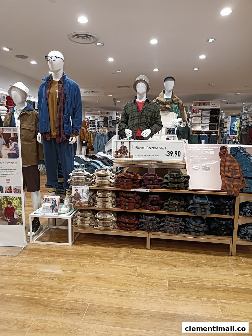 Mannequins display casual wear and flannel shirts inside a well-lit UNIQLO store.