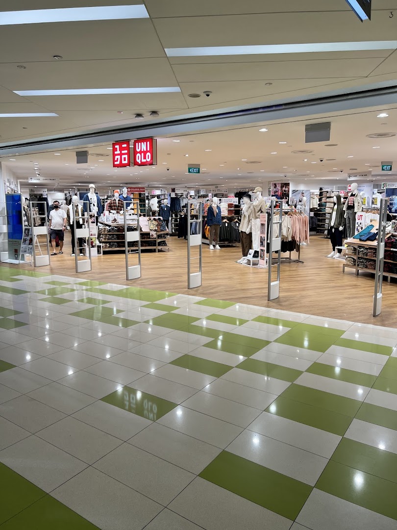 The inviting entrance of UNIQLO at The Clementi Mall, showcasing diverse fashion displays.